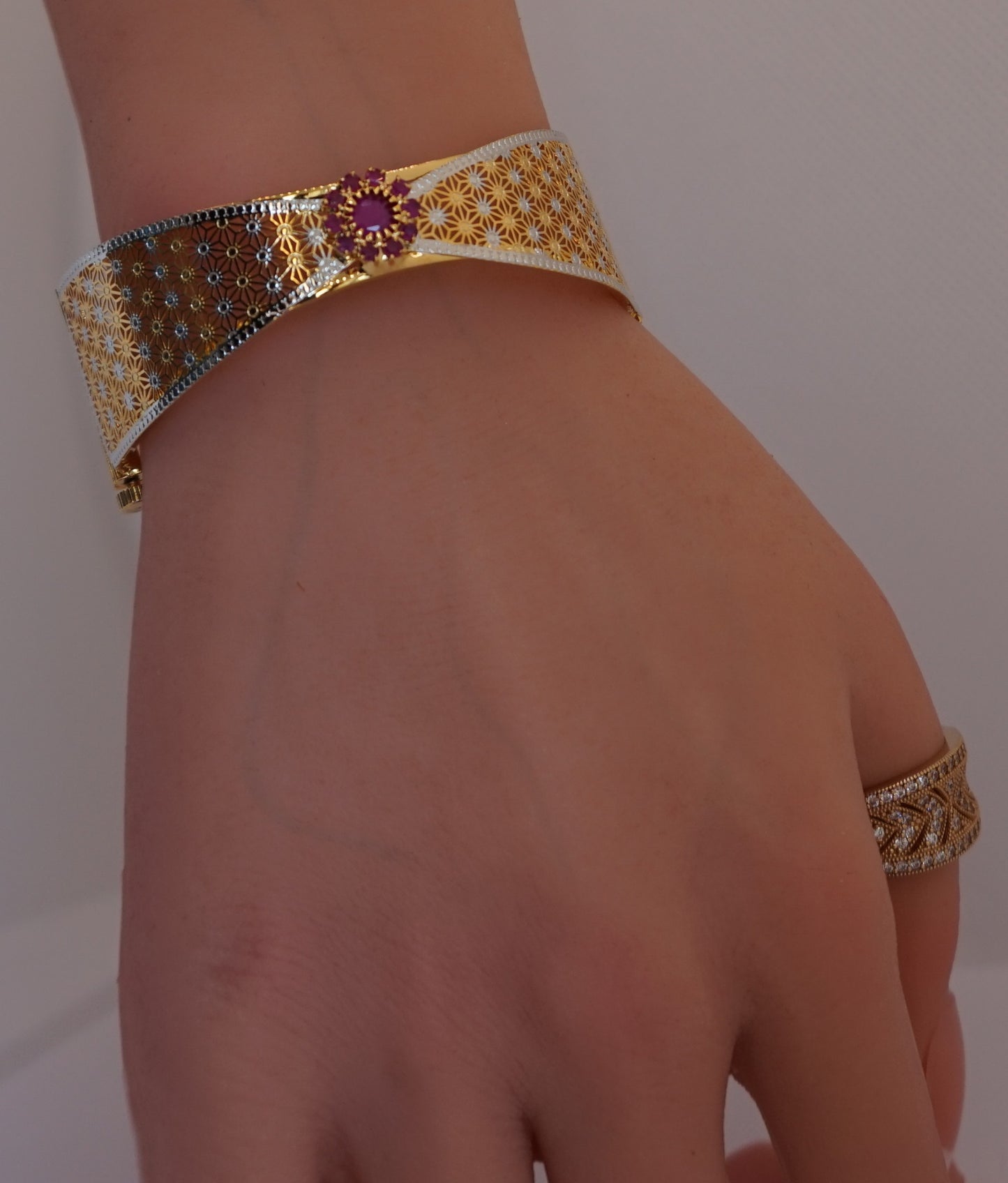 Bow tie bangle bracelet studded with red stones