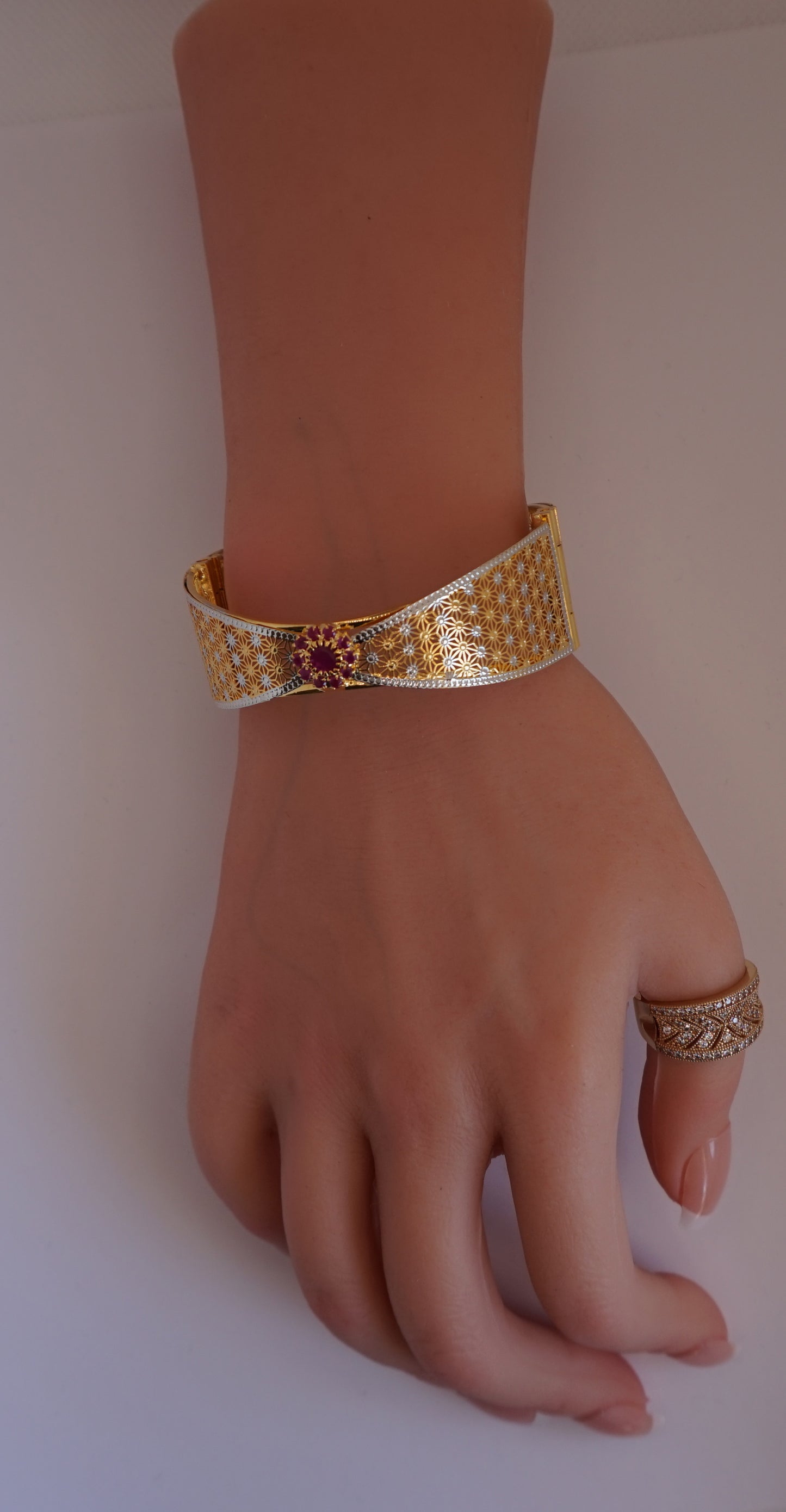 Bow tie bangle bracelet studded with red stones